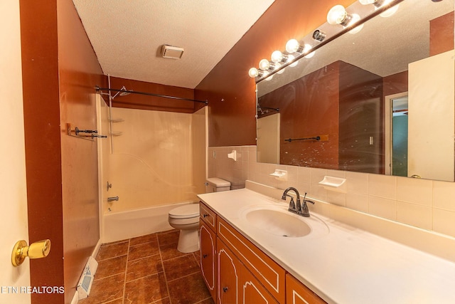 full bathroom featuring toilet, tile patterned flooring, tub / shower combination, a textured ceiling, and vanity