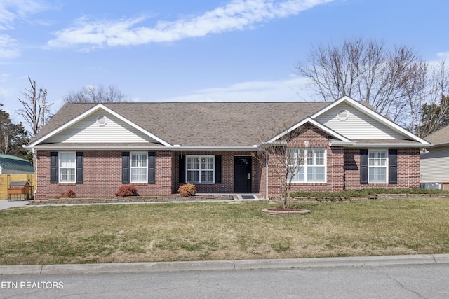 ranch-style house featuring brick siding, a front yard, and a shingled roof