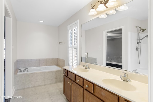 full bath featuring a bath, tile patterned flooring, double vanity, and a sink