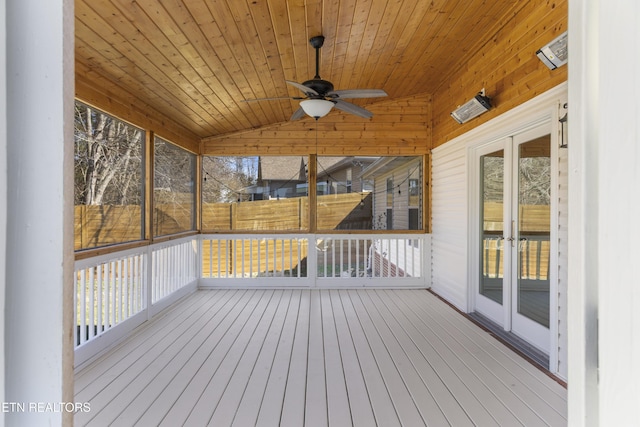 unfurnished sunroom featuring ceiling fan, wood ceiling, and vaulted ceiling