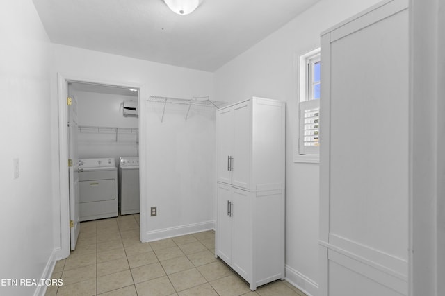 walk in closet featuring independent washer and dryer and light tile patterned floors