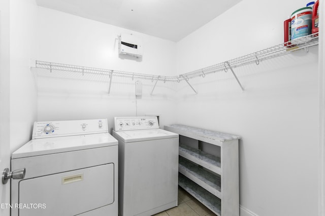 laundry room with light tile patterned floors, laundry area, and washer and clothes dryer