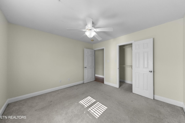 unfurnished bedroom with a closet, light carpet, ceiling fan, and baseboards