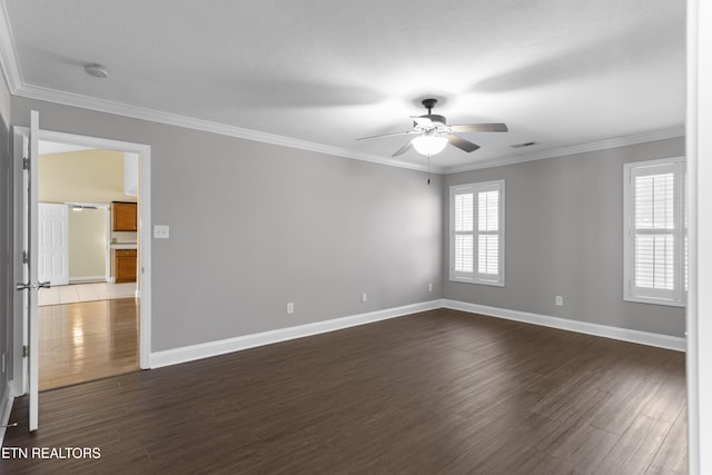 spare room with dark wood finished floors and crown molding