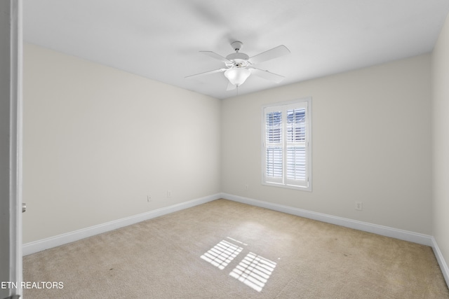 empty room featuring light carpet, ceiling fan, and baseboards