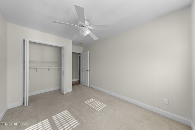 unfurnished bedroom with light carpet, a ceiling fan, baseboards, and a closet