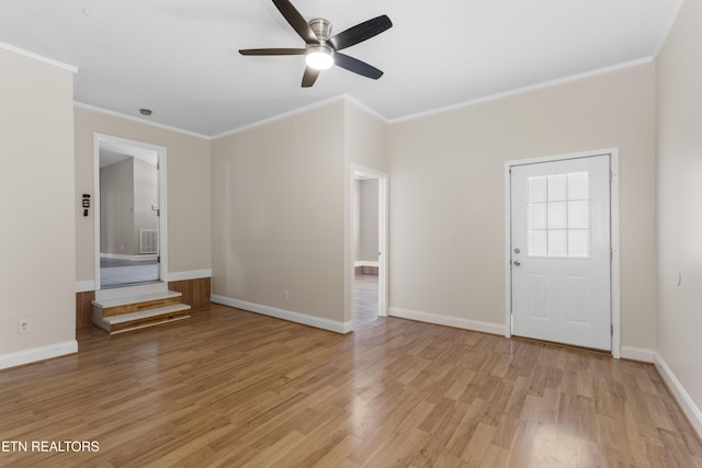 interior space with light wood-type flooring, baseboards, and ornamental molding