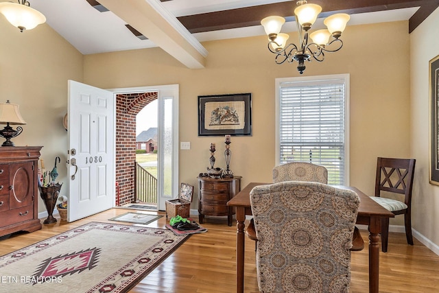 interior space featuring baseboards, wood finished floors, beam ceiling, and an inviting chandelier