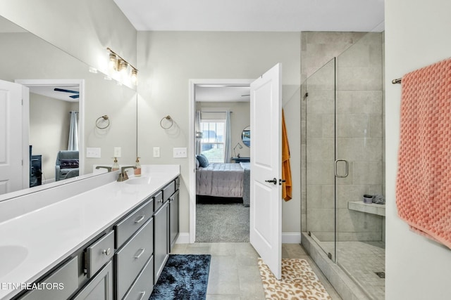 full bathroom with a sink, a shower stall, double vanity, and connected bathroom