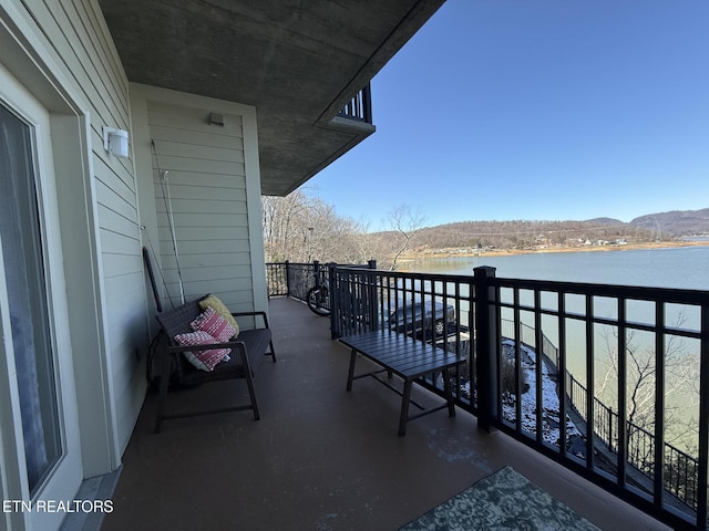 balcony with a water and mountain view