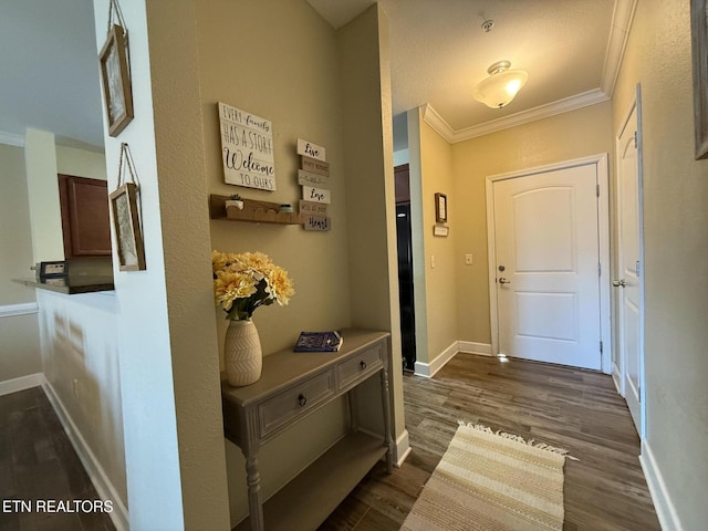 doorway to outside with ornamental molding, dark wood-type flooring, and baseboards