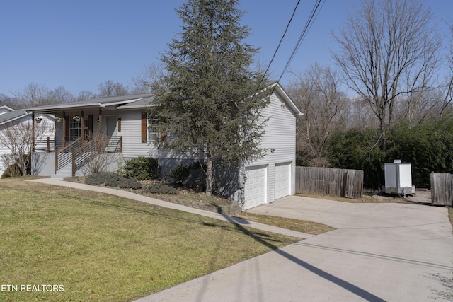 view of front of house featuring a front yard, fence, a porch, an attached garage, and concrete driveway