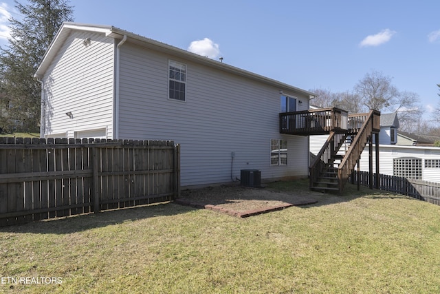 rear view of property with stairway, a wooden deck, a lawn, cooling unit, and a fenced backyard