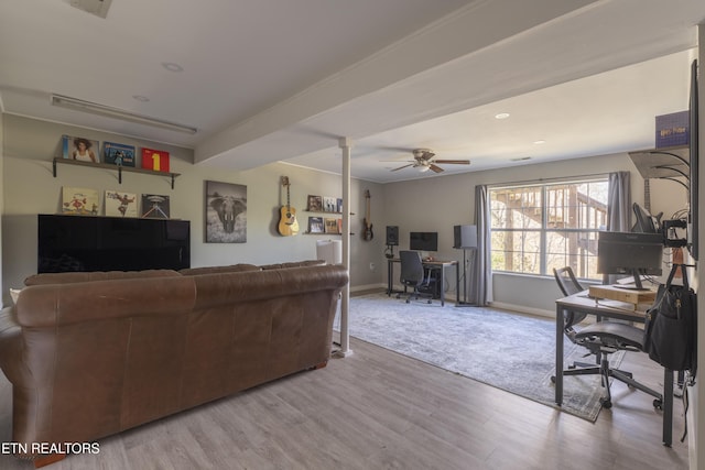 living room featuring baseboards, a ceiling fan, and light wood-style floors