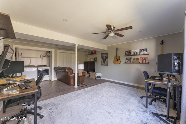 office with washing machine and dryer, baseboards, ceiling fan, and wood finished floors