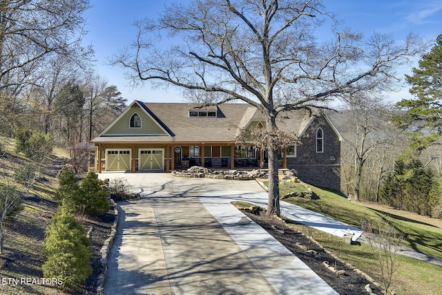 245 Harrison Bend Rd, Loudon, TN 37774 - view of front of property with covered porch, concrete driveway, and a garage