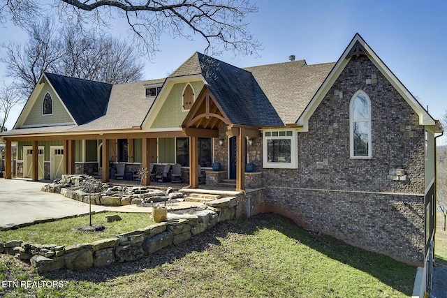 245 Harrison Bend Rd, Loudon, TN 37774 - view of front of house featuring concrete driveway, a patio area, stone siding, and a shingled roof