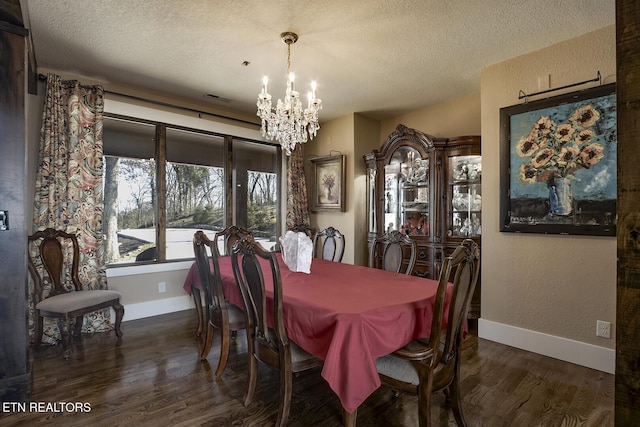 245 Harrison Bend Rd, Loudon, TN 37774 - dining area with baseboards, a notable chandelier, wood finished floors, and a textured ceiling