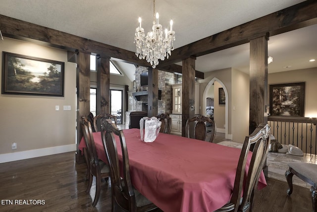 245 Harrison Bend Rd, Loudon, TN 37774 - dining space with baseboards, a chandelier, wood finished floors, arched walkways, and a textured ceiling