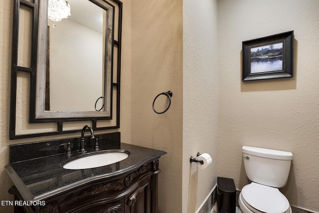 245 Harrison Bend Rd, Loudon, TN 37774 - bathroom featuring toilet, vanity, and a textured wall