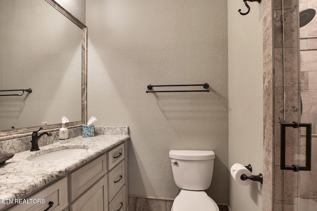 245 Harrison Bend Rd, Loudon, TN 37774 - full bathroom with a shower with shower door, toilet, vanity, and a textured wall