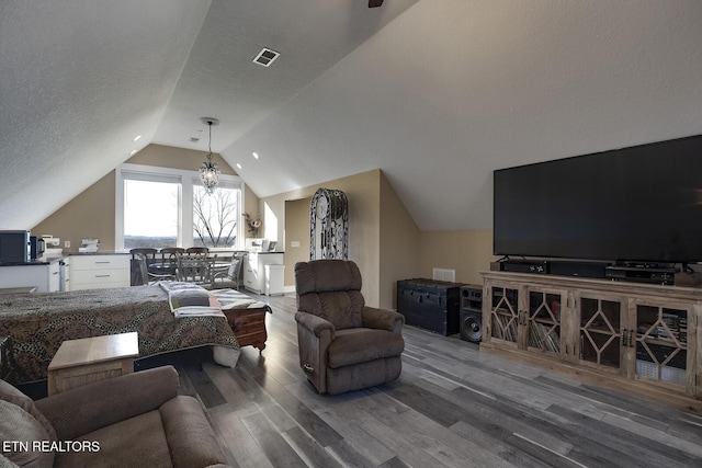 245 Harrison Bend Rd, Loudon, TN 37774 - living room featuring visible vents, a textured ceiling, wood finished floors, and vaulted ceiling