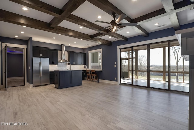245 Harrison Bend Rd, Loudon, TN 37774 - kitchen with visible vents, freestanding refrigerator, a sink, light countertops, and wall chimney range hood