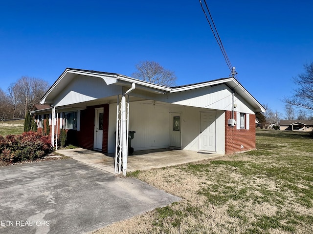 view of home's exterior with a yard and brick siding