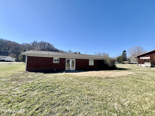 back of property featuring a lawn