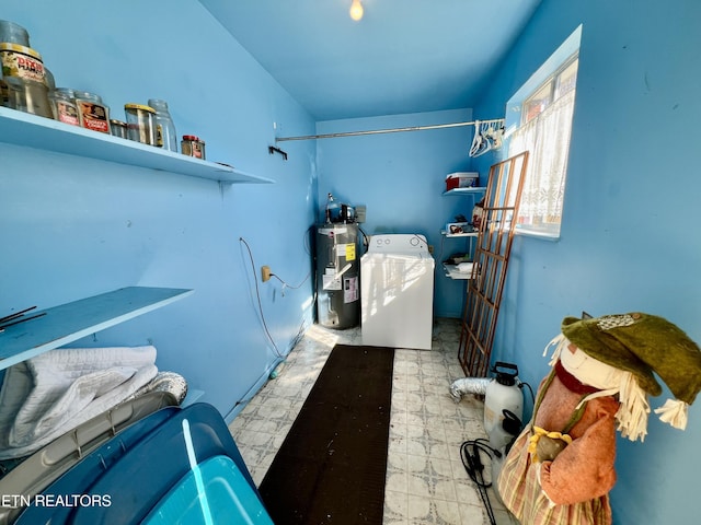 clothes washing area featuring washer / dryer, water heater, and tile patterned floors