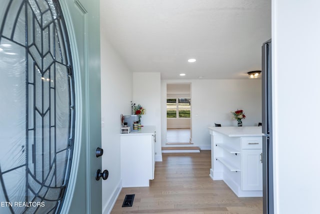 entrance foyer featuring recessed lighting, baseboards, visible vents, and light wood-type flooring