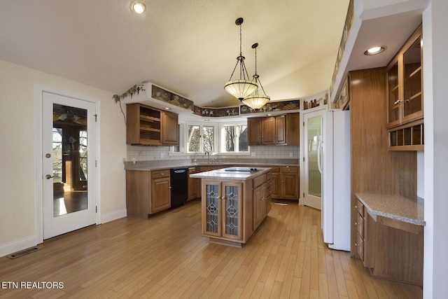 kitchen with black dishwasher, freestanding refrigerator, a sink, open shelves, and backsplash