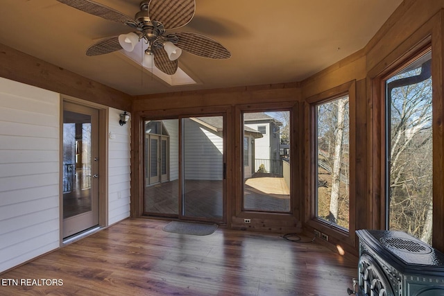 unfurnished sunroom with a ceiling fan