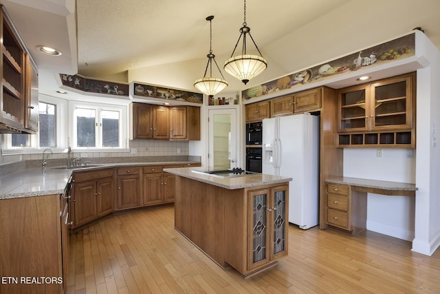 kitchen with open shelves, a sink, vaulted ceiling, built in study area, and white fridge with ice dispenser