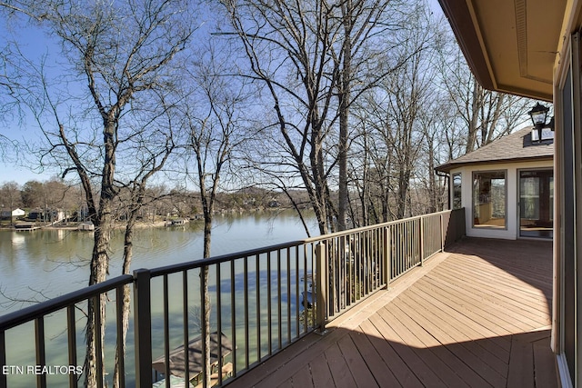 wooden terrace featuring a water view