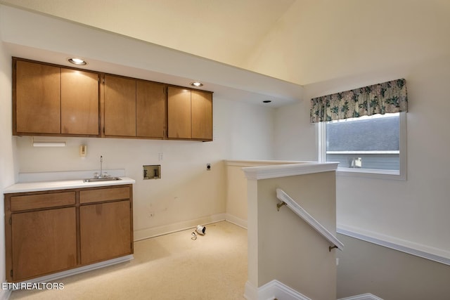 laundry area with washer hookup, cabinet space, a sink, electric dryer hookup, and baseboards