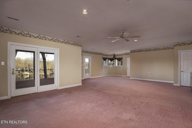 carpeted empty room with baseboards, visible vents, and recessed lighting