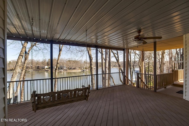 wooden terrace featuring a water view and a ceiling fan