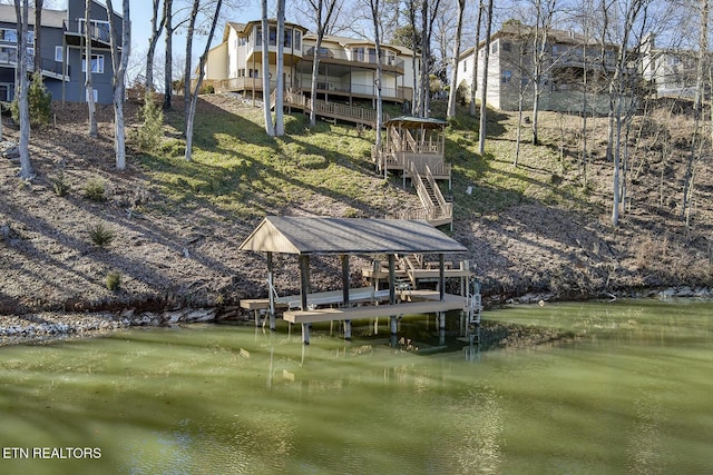 dock area featuring stairs and a deck with water view