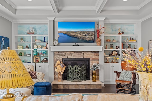 living area with beam ceiling, a fireplace, built in features, and wood finished floors