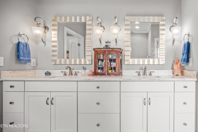 bathroom featuring a sink and double vanity