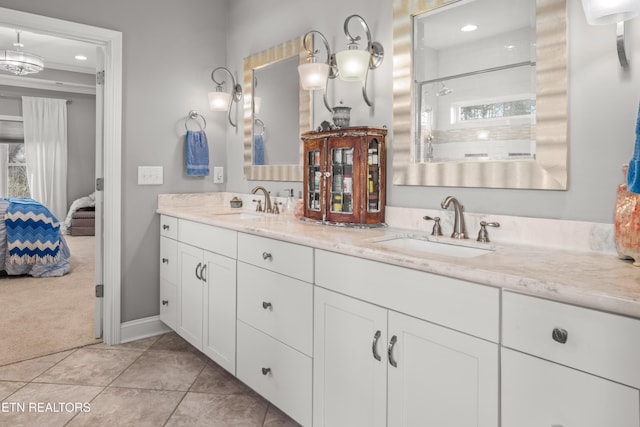 full bathroom with connected bathroom, tile patterned floors, a sink, and double vanity