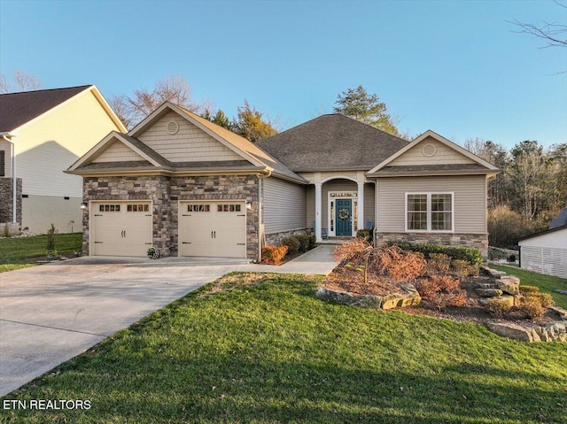 craftsman-style house with concrete driveway, a front lawn, an attached garage, and stone siding