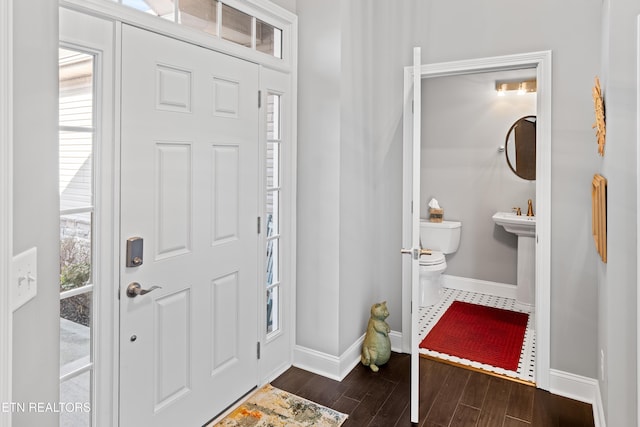 entrance foyer featuring dark wood-type flooring and baseboards