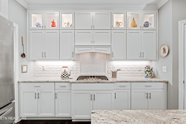 kitchen featuring appliances with stainless steel finishes, backsplash, and white cabinetry