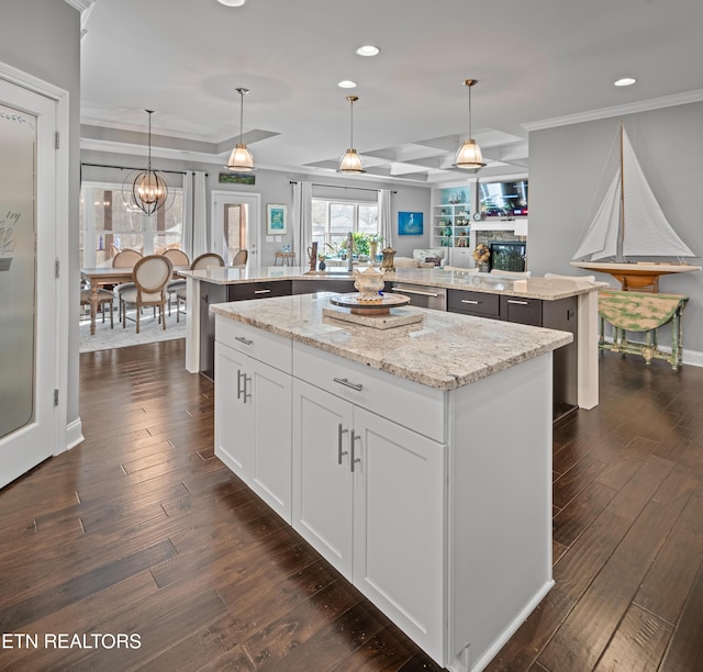 kitchen featuring crown molding, dark wood-style flooring, stainless steel dishwasher, and a center island