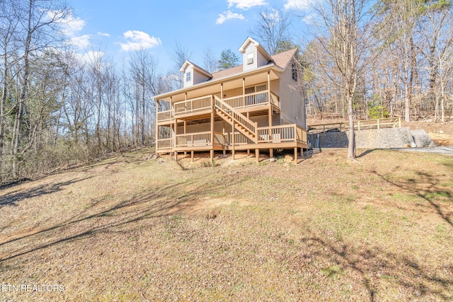 back of house featuring stairs and a wooden deck