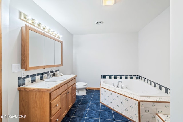 bathroom with a garden tub, visible vents, toilet, vanity, and tile patterned flooring