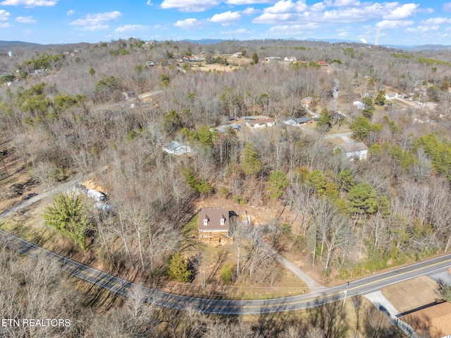 drone / aerial view featuring a forest view