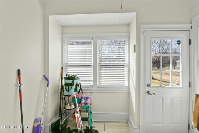 doorway to outside with baseboards